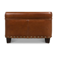 Back view of leather ottoman with decorative nailheads.