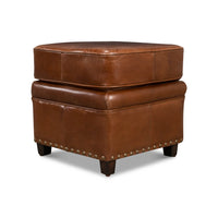 Leather ottoman angled view highlighting its square design.