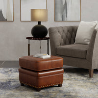 Brown ottoman in living room with sofa and lamp.
