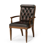 Leather tufted dining armchair angled front view.