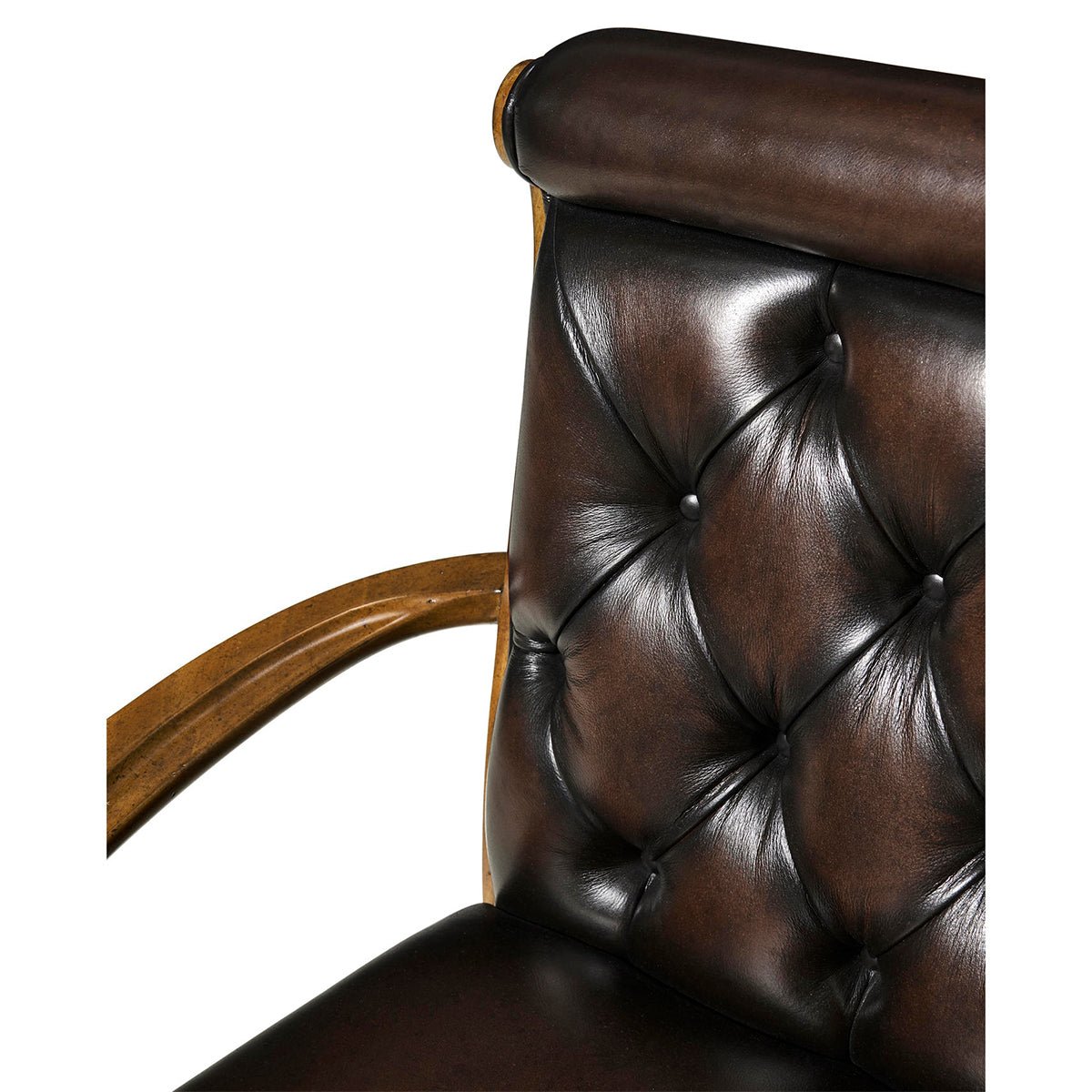 Close up of chair's leather arm and tufting.