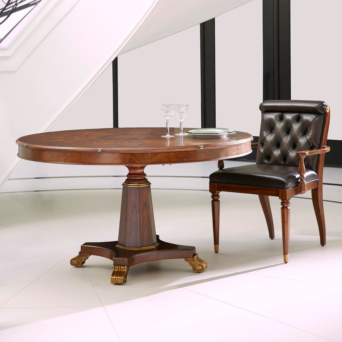 Dining armchair beside round table, modern setting.
