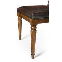 Chair leg detail, wood craftsmanship of tufted dining chair.