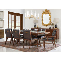 Dining room setup featuring classic leather tufted dining chairs.