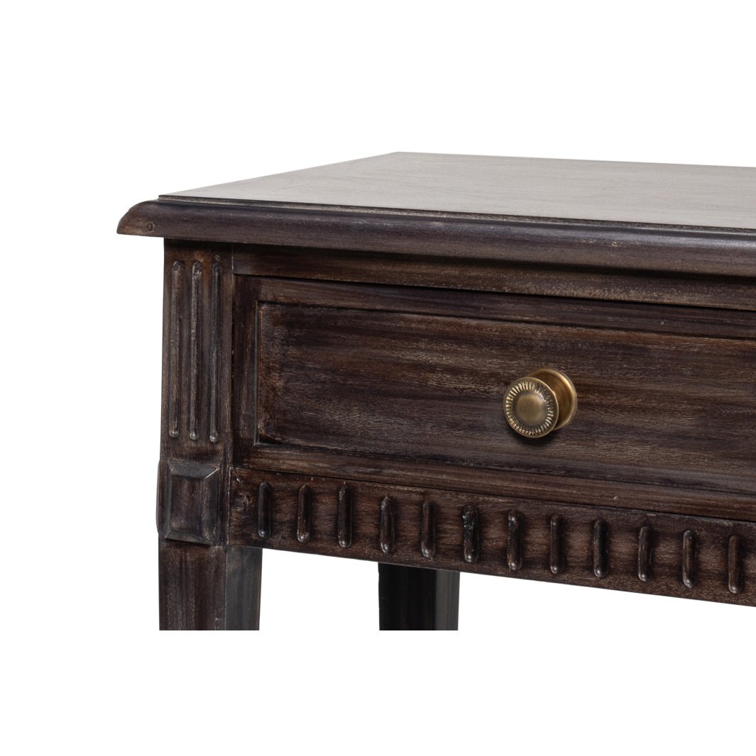 Close-up of table corner emphasizing drawer and woodwork.