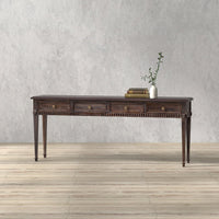 Console table on light wood floor with plant decor.