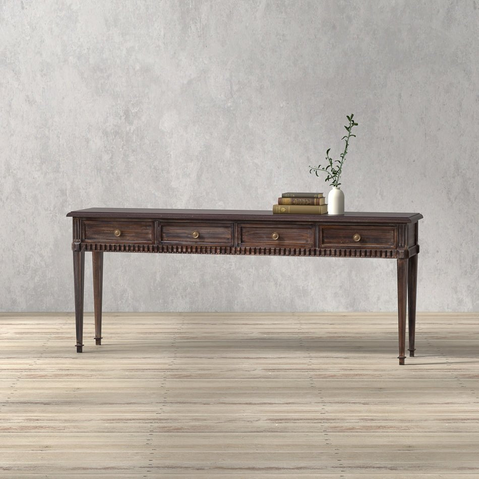 Console table on light wood floor with plant decor.