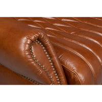 Leather chair armrest details, close-up view.