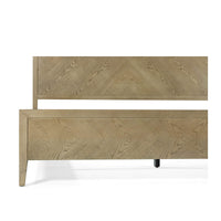 Close-up of footboard on light wood bed frame.