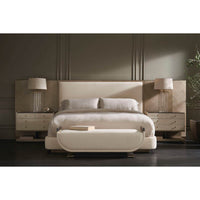 Bedroom scene featuring upholstered queen bed with decor.