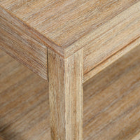 Corner detail of weathered side table, wood grain visible.