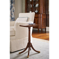 Octagonal accent table beside armchair in living room.