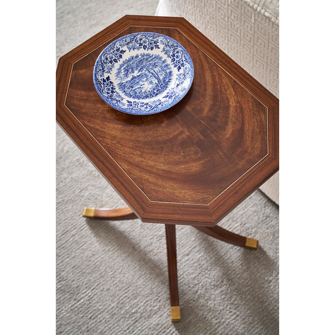 Top view of octagonal accent table with decorative plate.