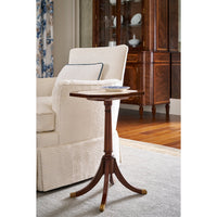 Marble top accent table beside a cream sofa.