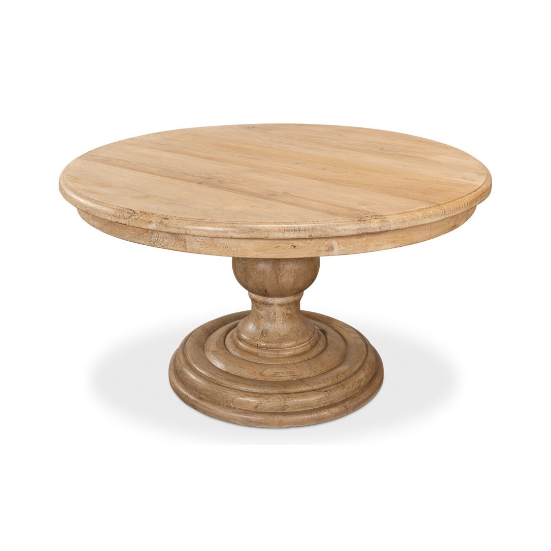 Angled view of round pedestal dining table.