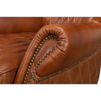 Close-up of armchair's armrest and nailhead trim.