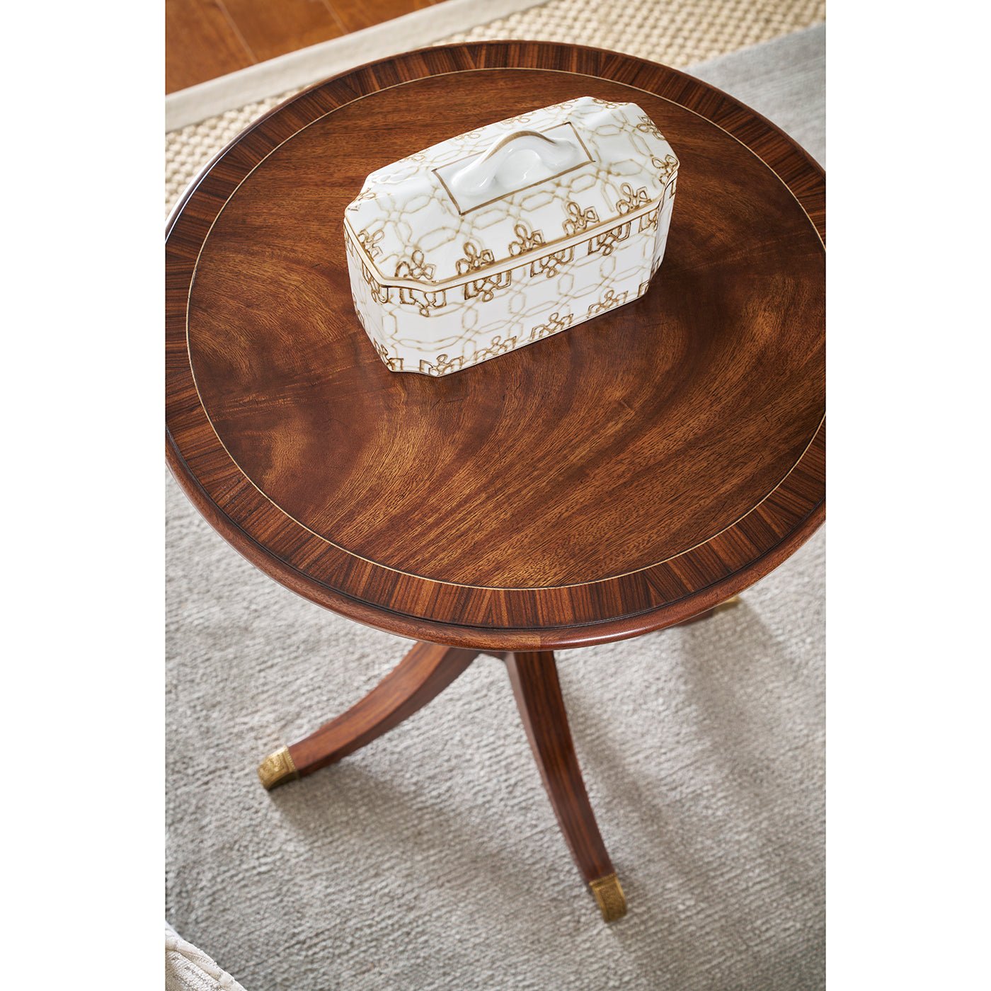 Wooden classic round accent table top view with decorative box.