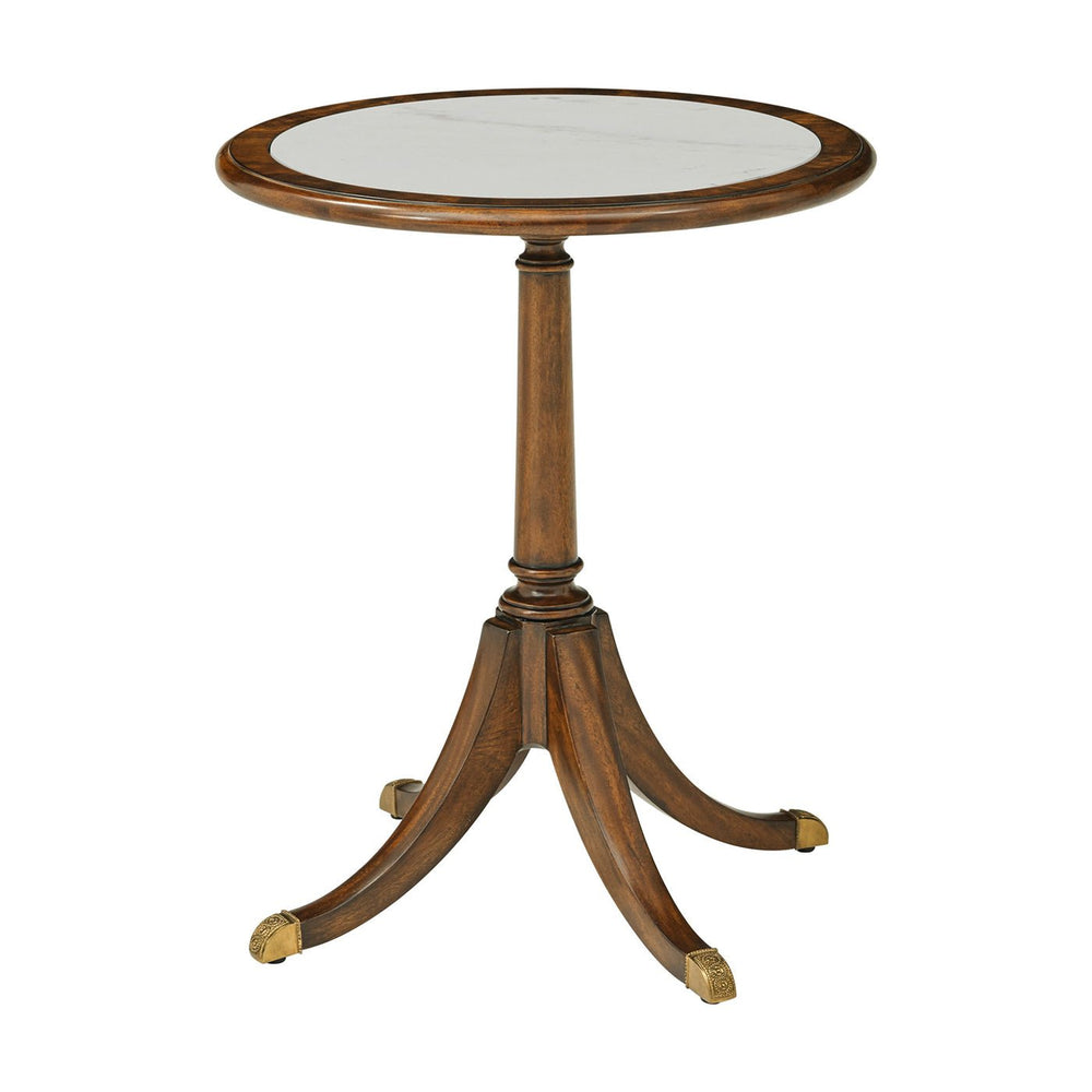 Round marble top accent table on white background.