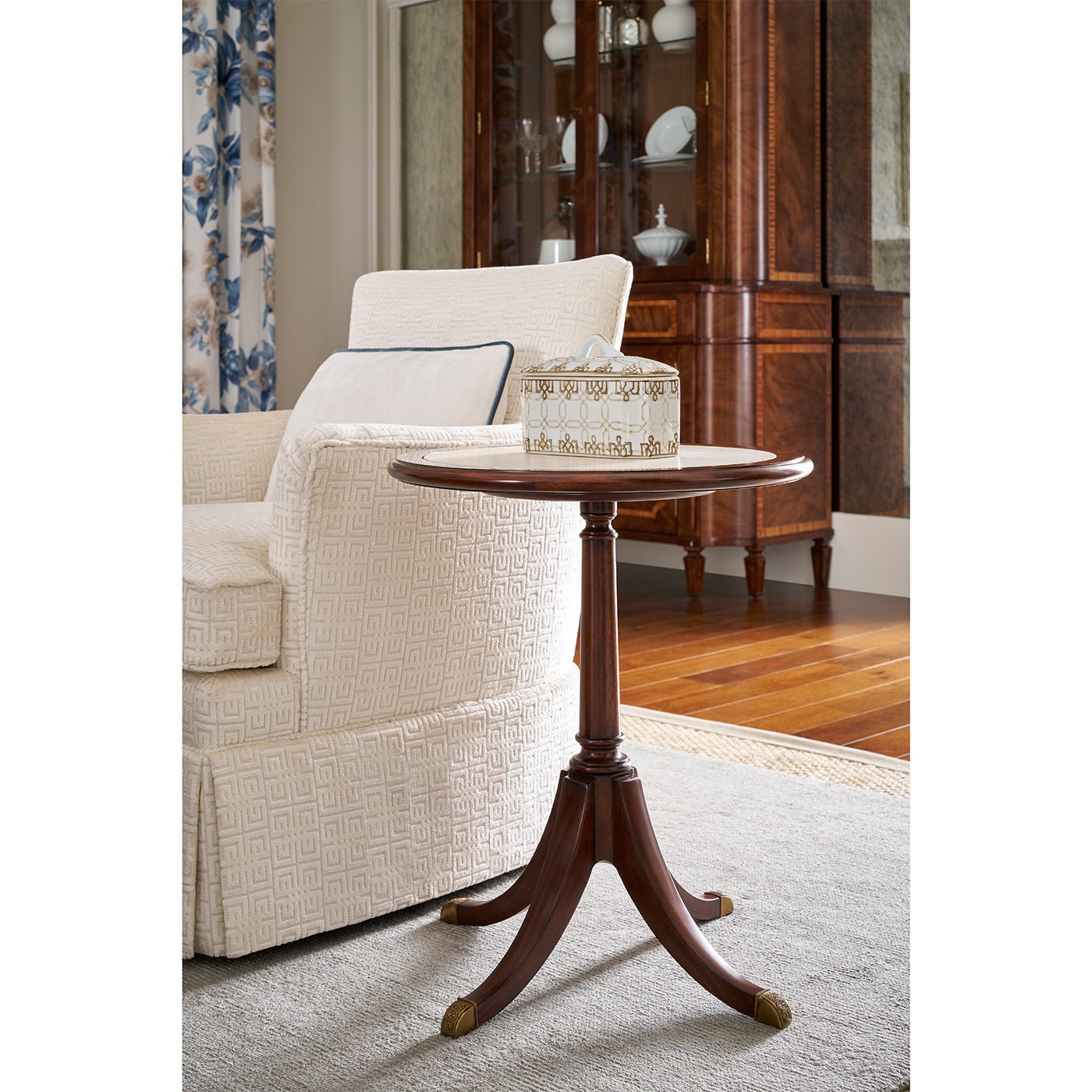 Accent table next to cream chair in living room.