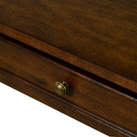 Console table drawer close-up, brass knob detail.