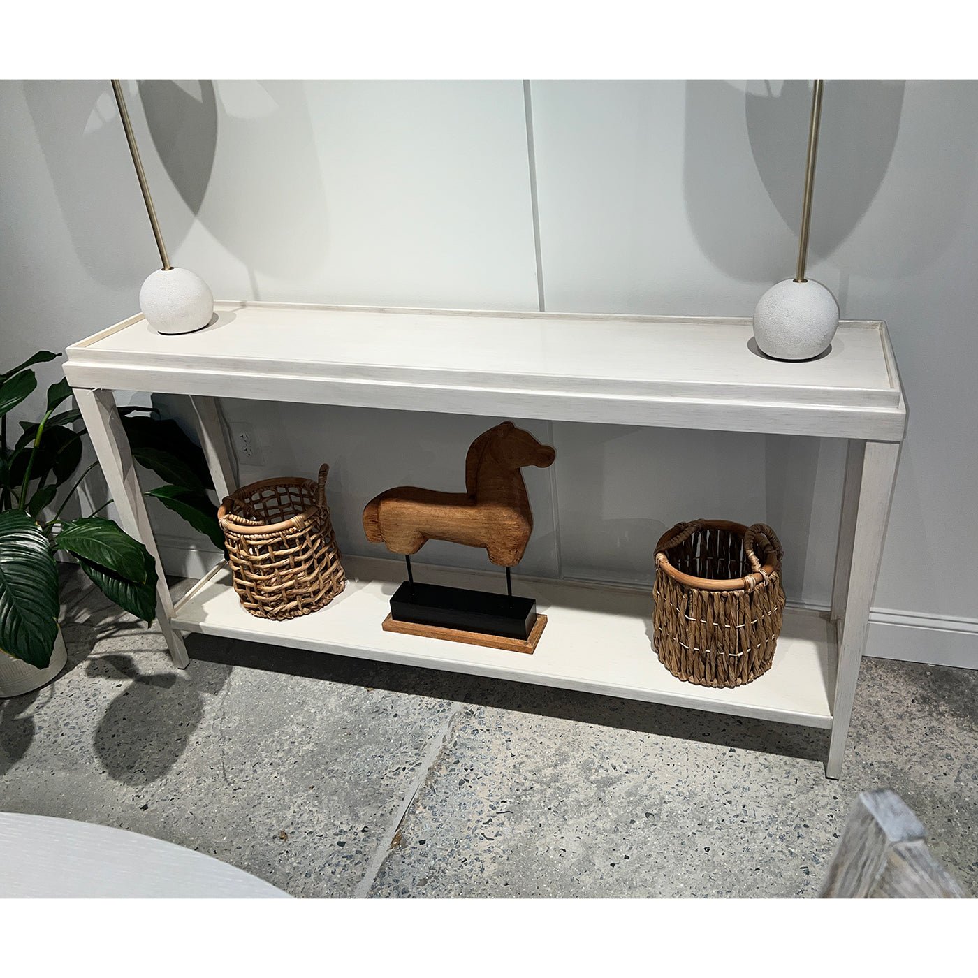 Console table with baskets and decor accents.