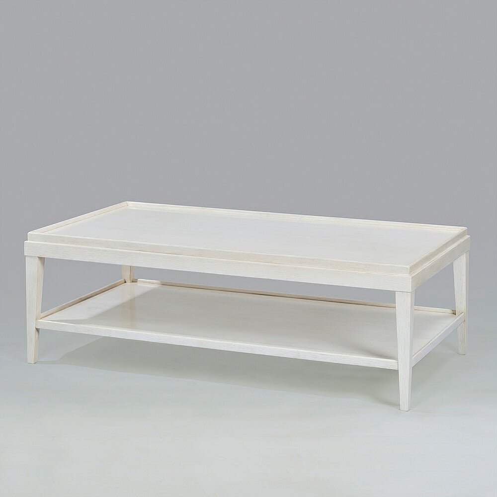 Angled view of white lacquer rectangular coffee table.