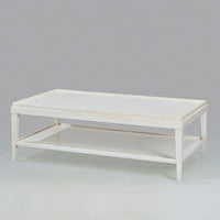 Angled view of white lacquer rectangular coffee table.