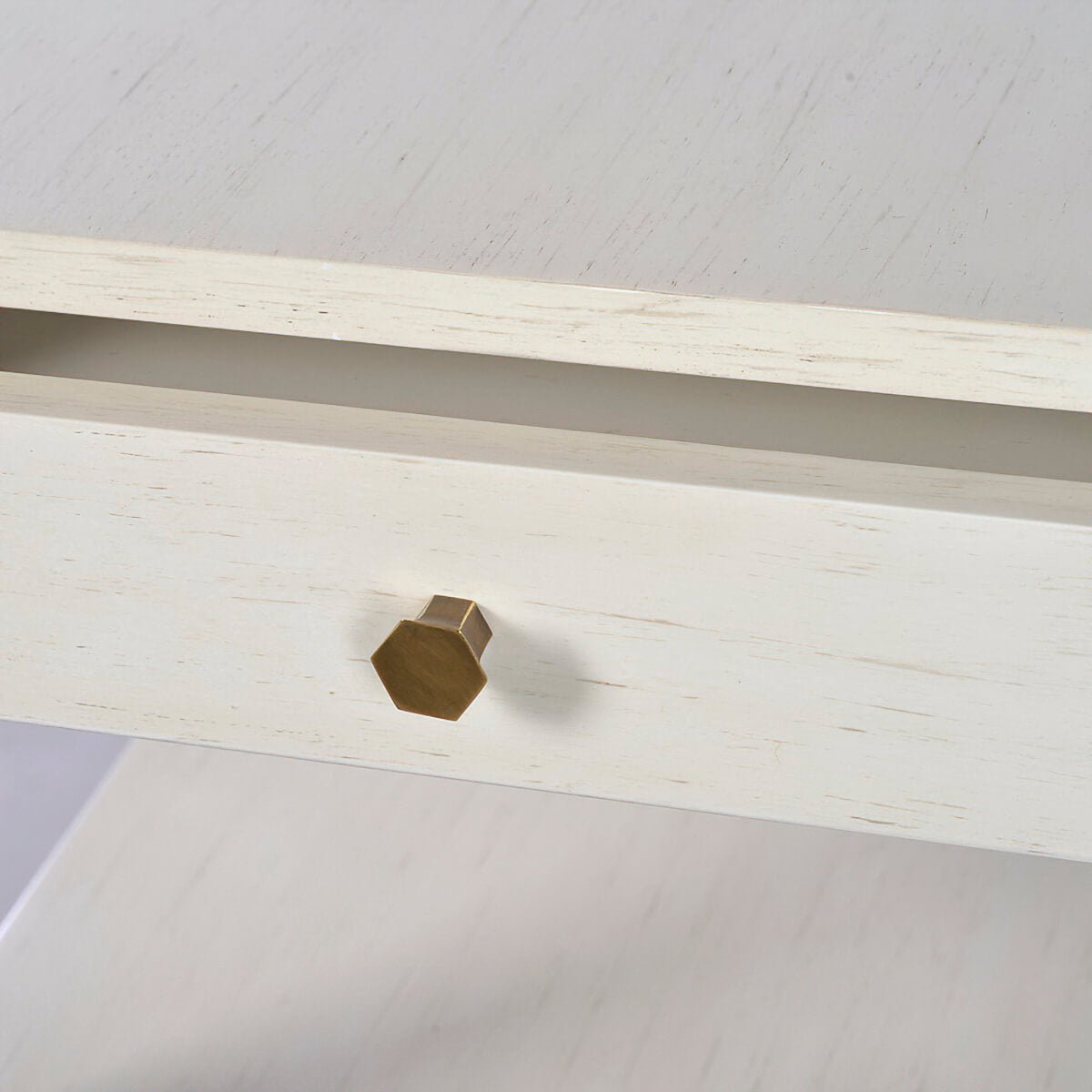 Close-up of side table drawer knob, hexagonal design.