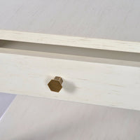 Close-up of side table drawer knob, hexagonal design.