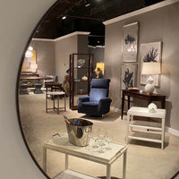 Showroom interior featuring side table amid modern furniture.