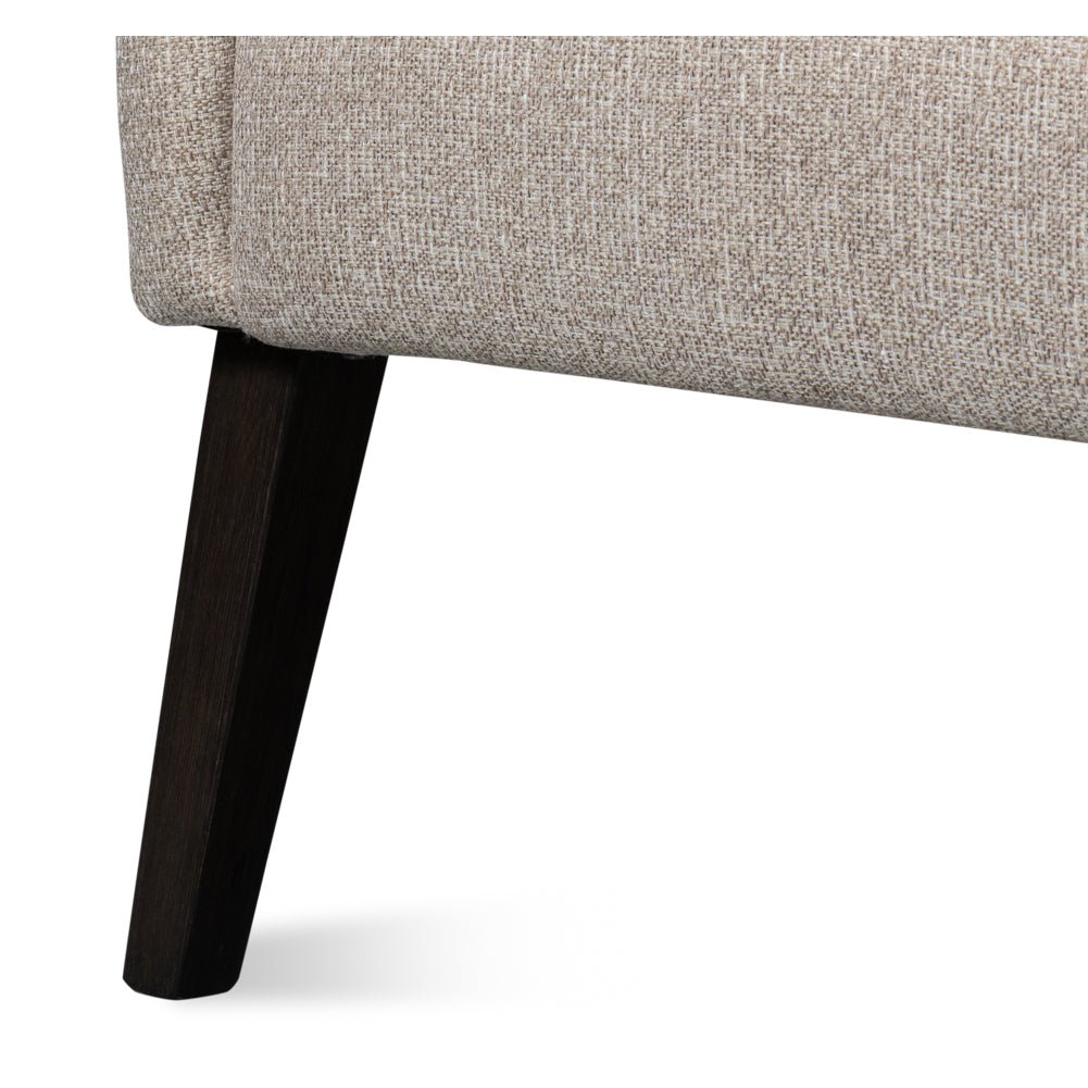 Classic tub chair leg detail with dark wood finish.