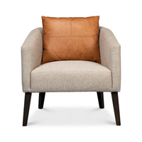 Classic tub chair front close-up with leather pillow.