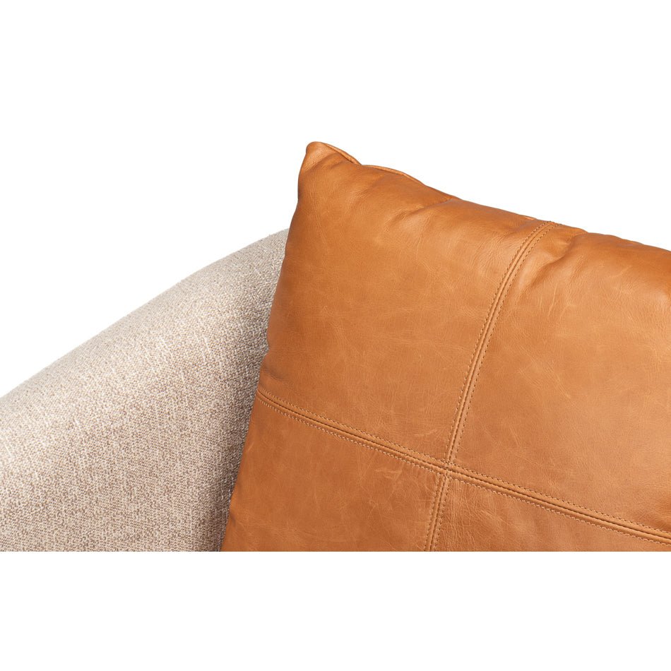 Close-up of brown cushion on swivel chair, stitching detail.
