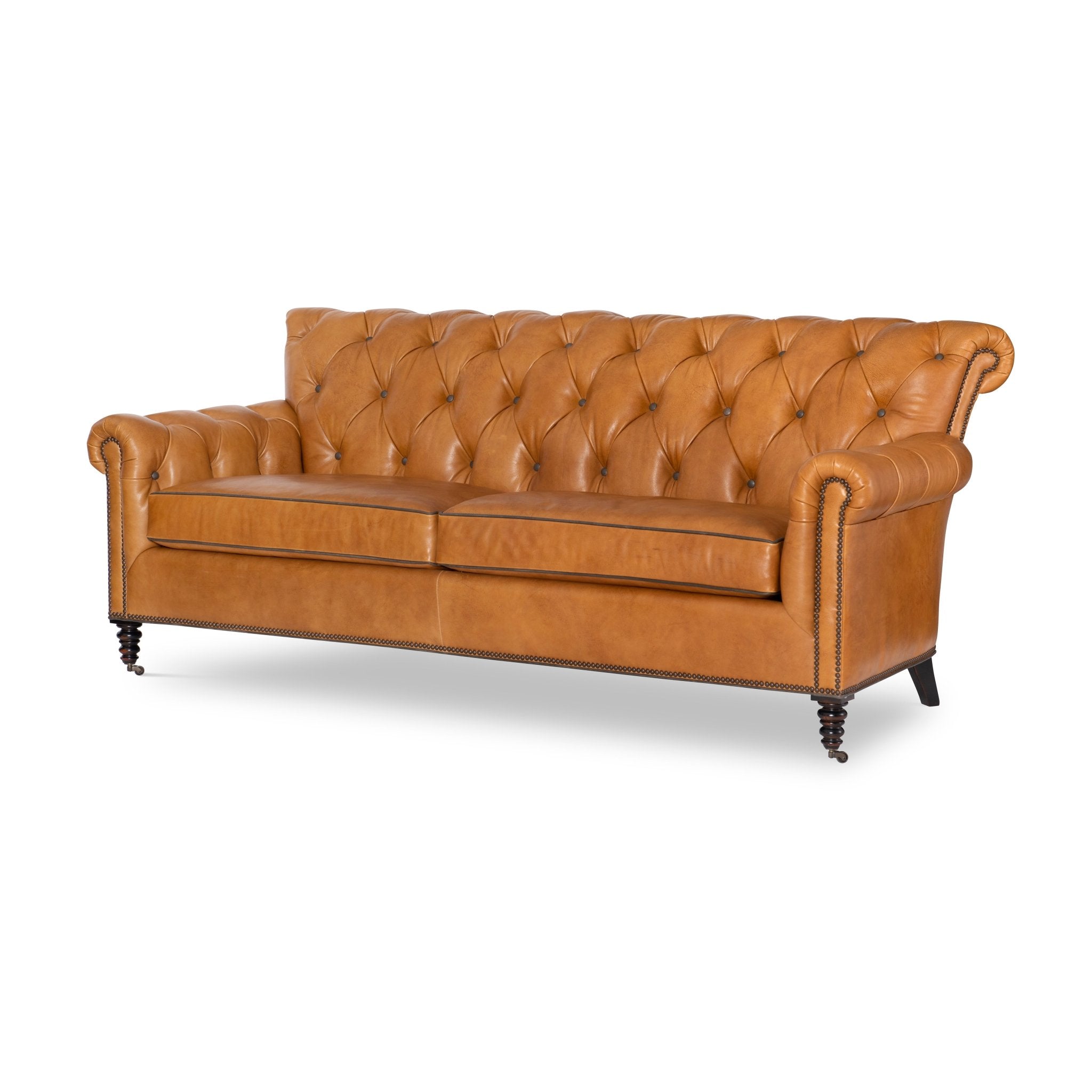 Brown tufted leather sofa, front angle view, classic design.