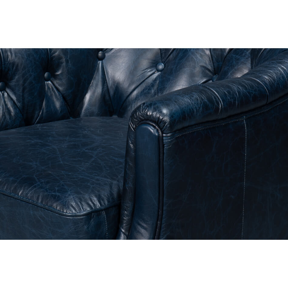 Close-up of armrest on blue leather armchair.