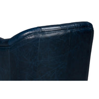 Backrest detail on blue leather armchair.