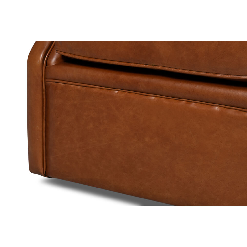 Brown leather armchair, close-up of base, smooth leather material.