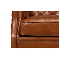 Brown leather armchair, close-up of cushions, detailed leather.