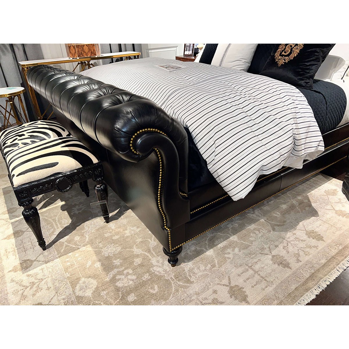 Corner detail of classic tufted leather king bed.