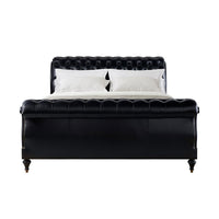 Front view of classic tufted leather king bed.