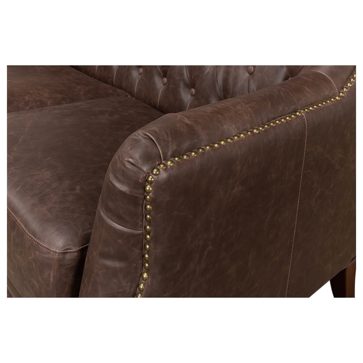 Detail of armrest with nailhead trim, tufted love seat.