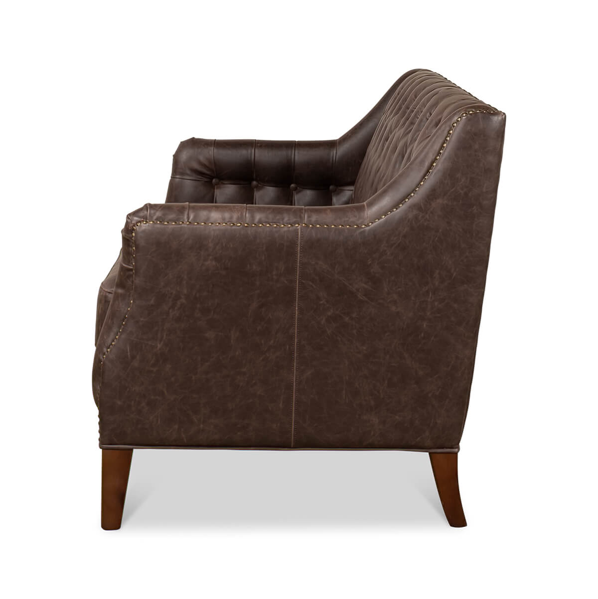 Side profile of tufted love seat, brown upholstery.