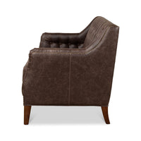 Side profile of tufted love seat, brown upholstery.