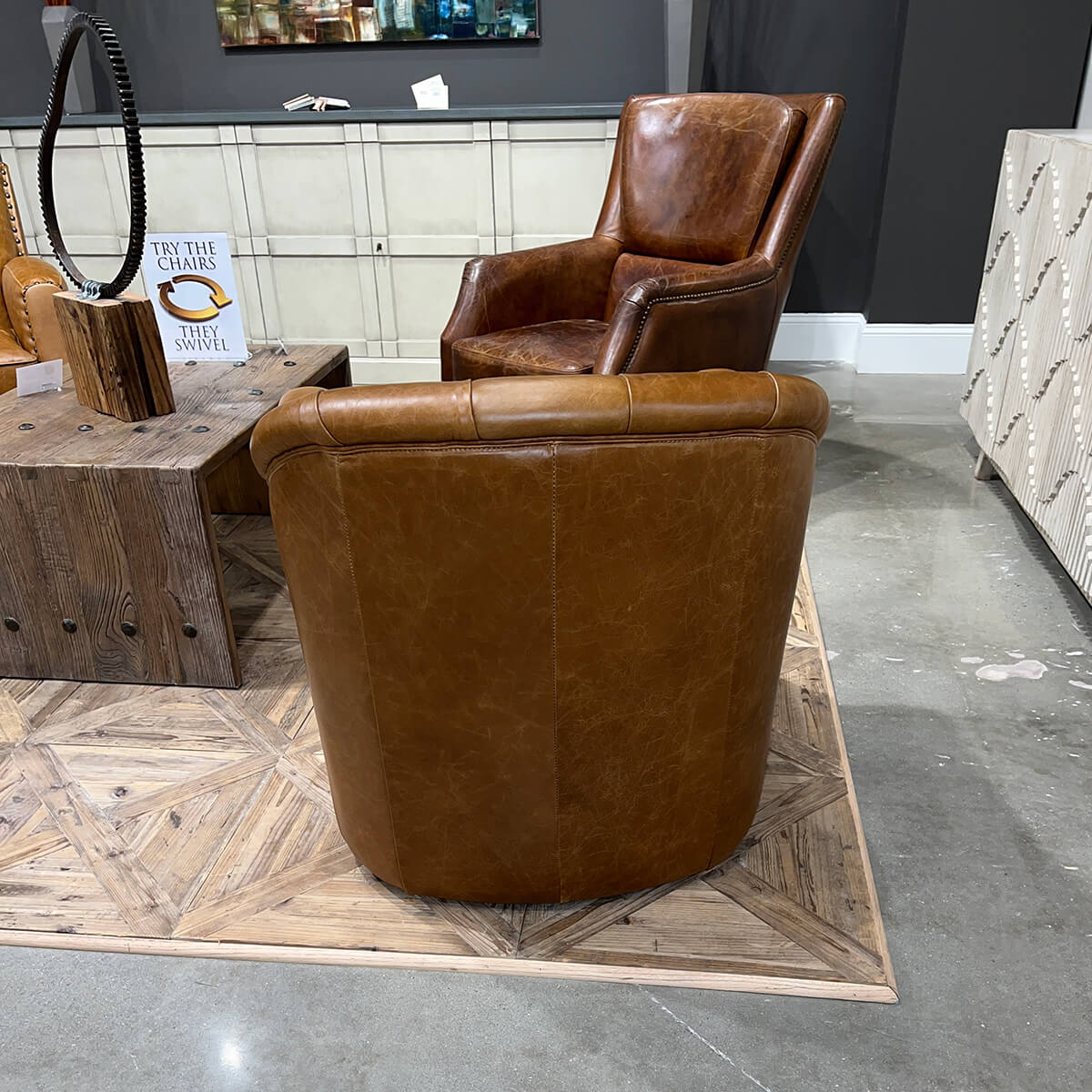 Brown tufted armchair, back view in room, other furniture.