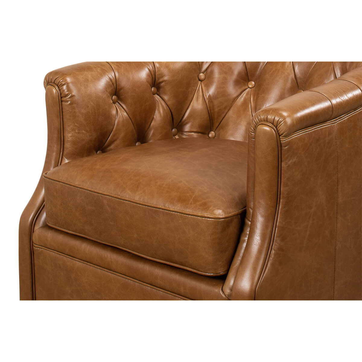 Brown tufted armchair, close-up of arm and cushion.