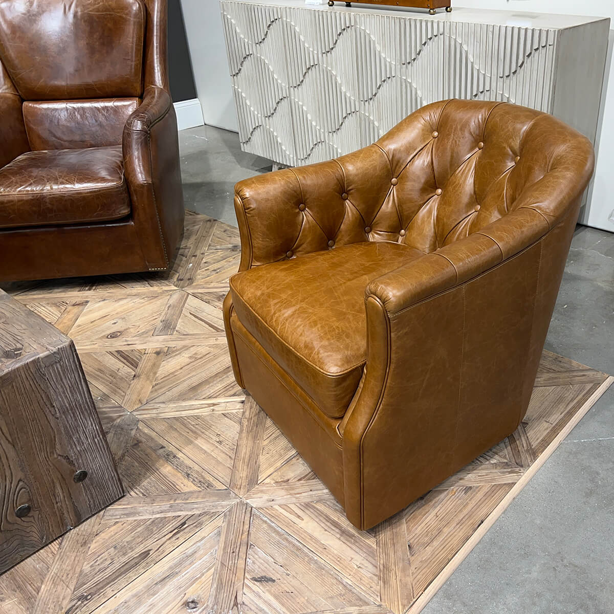 Brown tufted armchair, angled view in room setting.
