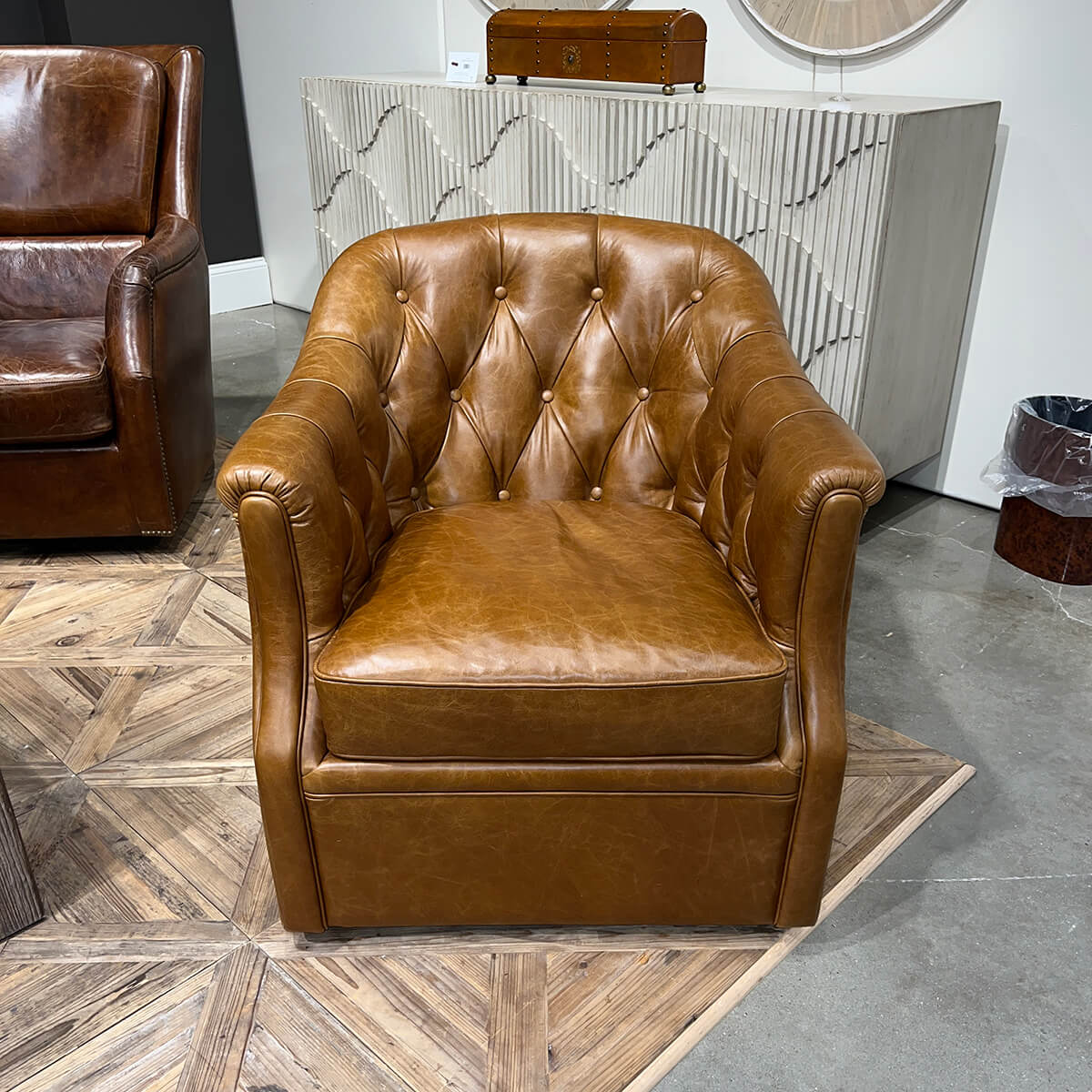 Brown tufted armchair, front view, in living room setting.
