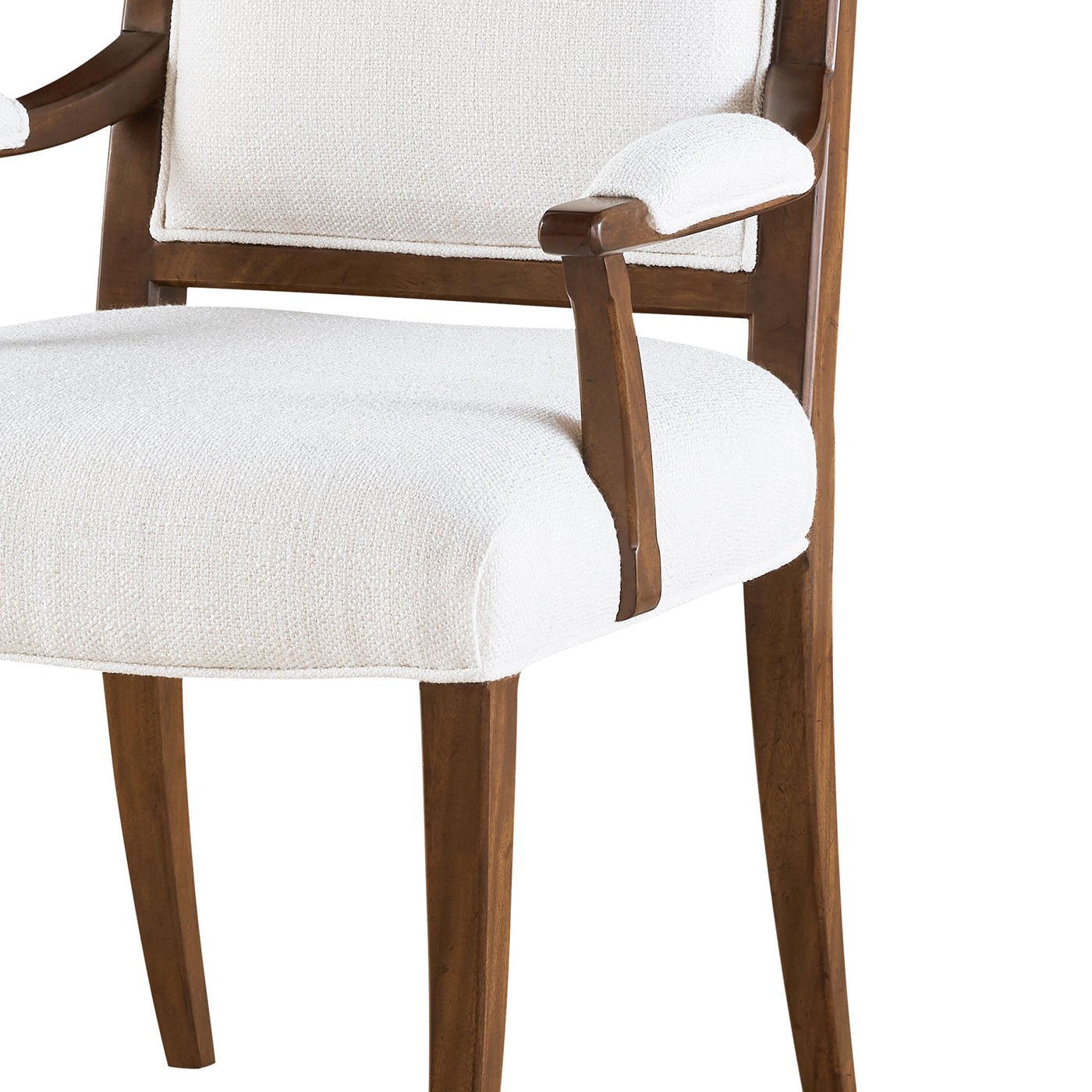 Close-up of classic upholstered armchair seat and arm detail.