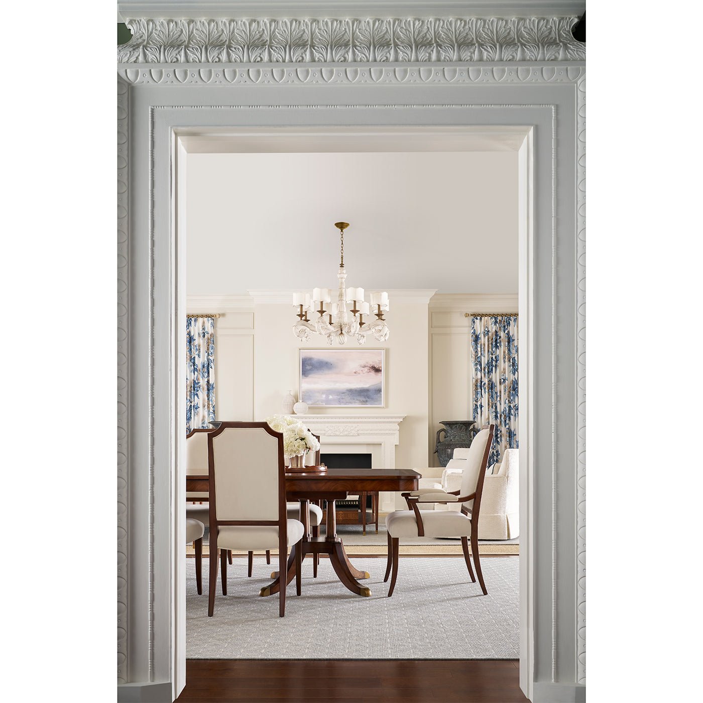 Dining room scene with upholstered chairs around wooden table.
