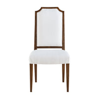 Front view of a white upholstered dining chair.